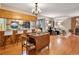 Open-concept living room features a dining area, kitchen, and a cozy seating area with a fireplace at 9411 W 89Th Cir, Westminster, CO 80021