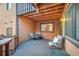 Cozy outdoor patio with wood ceiling, table, chairs, and ample seating for outdoor enjoyment at 9411 W 89Th Cir, Westminster, CO 80021