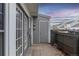 Enclosed back patio featuring gray siding, a storage shed, and sliding glass doors for seamless indoor-outdoor living at 19618 Rosewood Ct, Parker, CO 80138