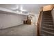 Spacious basement featuring neutral carpet, a convenient sink area, and access to the upper level via staircase at 19618 Rosewood Ct, Parker, CO 80138