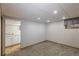 The basement features neutral carpet and a convenient sink area, with a bright window adding natural light at 19618 Rosewood Ct, Parker, CO 80138