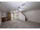 Open basement featuring neutral carpet, access to the upper level via staircase, and a convenient sink area at 19618 Rosewood Ct, Parker, CO 80138