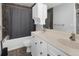 Bathroom with a double sink vanity, tub with shower, and tile flooring at 19618 Rosewood Ct, Parker, CO 80138