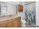 Bathroom with a wood vanity, stylish faucet, and shower with a curtain at 19618 Rosewood Ct, Parker, CO 80138