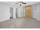 Bright bedroom featuring a ceiling fan, large closet, and an adjacent bathroom at 19618 Rosewood Ct, Parker, CO 80138