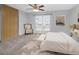 Cozy bedroom with ceiling fan, large window, closet, and seating area at 19618 Rosewood Ct, Parker, CO 80138