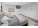 Staged bedroom with soft gray decor, ample storage with built-in shelving, and a bright window at 19618 Rosewood Ct, Parker, CO 80138