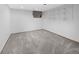 Empty bedroom with neutral carpet, a bright window, and ample storage with built-in shelving at 19618 Rosewood Ct, Parker, CO 80138