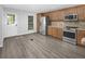 Open kitchen space featuring stainless steel appliances and lots of wood cabinets at 19618 Rosewood Ct, Parker, CO 80138