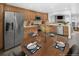 The kitchen features stainless appliances, wood cabinets, and an adjacent dining space at 19618 Rosewood Ct, Parker, CO 80138