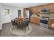 Bright eat-in kitchen featuring stainless steel appliances and wood cabinets with a cozy dining area at 19618 Rosewood Ct, Parker, CO 80138