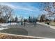 Vibrant community playground featuring swings and play structures with snowy patches nearby at 19618 Rosewood Ct, Parker, CO 80138