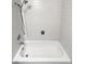 Bathroom featuring a pristine white tiled tub and shower, with classic fixtures and clean lines at 3661 S Joplin St, Aurora, CO 80013