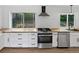 Bright kitchen boasting stainless steel appliances, wood countertops, and a large window at 3661 S Joplin St, Aurora, CO 80013