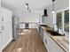 Spacious kitchen featuring stainless steel appliances, butcher block countertops, and ample cabinet space at 3661 S Joplin St, Aurora, CO 80013
