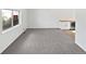 Living room featuring new carpet, large window, and a built-in wet bar at 3661 S Joplin St, Aurora, CO 80013