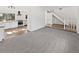Open-concept living room featuring new carpeting and stairs leading to the upper level at 3661 S Joplin St, Aurora, CO 80013