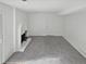 Spacious living room with new carpeting and a painted brick fireplace feature at 3661 S Joplin St, Aurora, CO 80013