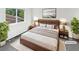 Staged main bedroom featuring natural light, neutral colors, and calming decor at 3661 S Joplin St, Aurora, CO 80013