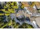 Aerial view of a large home surrounded by trees with a driveway covered in snow at 50 Cooney Ct, Breckenridge, CO 80424