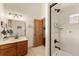 Bathroom with bronze fixtures, a tile shower, and wood door at 50 Cooney Ct, Breckenridge, CO 80424