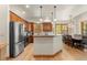 Open kitchen and dining area with stainless steel appliances, wood cabinets, and natural light at 50 Cooney Ct, Breckenridge, CO 80424