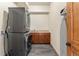 The laundry room features stacked washer and dryer with wood cabinetry at 50 Cooney Ct, Breckenridge, CO 80424