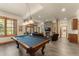 Finished basement with a pool table, stone fireplace, and plush leather furniture at 50 Cooney Ct, Breckenridge, CO 80424