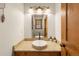 Stylish powder room featuring granite countertop, vessel sink, and decorative lighting fixtures at 50 Cooney Ct, Breckenridge, CO 80424