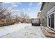 Large backyard with a hot tub and snow-covered patio at 10251 Rifle St, Commerce City, CO 80022