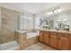 Elegant bathroom with soaking tub, shower, and double vanity at 10251 Rifle St, Commerce City, CO 80022