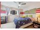 Bright bedroom featuring a ceiling fan and colorful decor at 10251 Rifle St, Commerce City, CO 80022