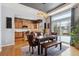 Bright dining room with a wooden table and leather chairs, open to kitchen at 10251 Rifle St, Commerce City, CO 80022