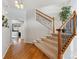 Elegant entryway with hardwood floors, a staircase with iron railings, and a view into the living room at 10251 Rifle St, Commerce City, CO 80022