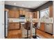 Modern kitchen with light wood cabinets, granite countertops, and a center island at 10251 Rifle St, Commerce City, CO 80022