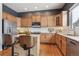 Modern kitchen with light wood cabinets, granite countertops, and a breakfast bar at 10251 Rifle St, Commerce City, CO 80022