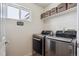 Convenient laundry room with washer, dryer, and storage shelves at 10251 Rifle St, Commerce City, CO 80022