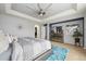 Main bedroom with large bed, dresser, and ceiling fan at 10251 Rifle St, Commerce City, CO 80022