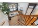 Open staircase with wrought iron railings and hardwood floors, overlooking the living room at 10251 Rifle St, Commerce City, CO 80022