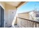 Outdoor balcony with neutral paint, white wooden railing, and a storage unit at 9973 E Carolina Cir # 104, Aurora, CO 80247