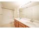 Bathroom with double vanity, a large mirror, and a shower over tub with white tiling at 9973 E Carolina Cir # 104, Aurora, CO 80247