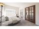 Cozy bedroom featuring a large window and stylish french doors leading to the living room at 9973 E Carolina Cir # 104, Aurora, CO 80247