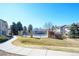 Community pool area surrounded by a fence, mature trees, and well manicured landscaping at 9973 E Carolina Cir # 104, Aurora, CO 80247