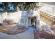 Charming condo front entrance featuring stone accents, a red front door, and well maintained landscaping at 9973 E Carolina Cir # 104, Aurora, CO 80247