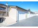 Detached garages in a row with light colored siding, garage door panels, and dark trim at 9973 E Carolina Cir # 104, Aurora, CO 80247