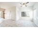 Well-lit living room featuring tile floors, large windows, and a ceiling fan at 9973 E Carolina Cir # 104, Aurora, CO 80247