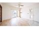 Well-lit living room featuring hard wood floors, access to a balcony and a ceiling fan at 9973 E Carolina Cir # 104, Aurora, CO 80247