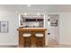 Finished basement bar area with barstool seating and a pass-through window into the kitchen at 2745 N Saint Paul St, Denver, CO 80205