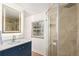 Beautifully renovated bathroom with walk-in shower, modern tiling, and vanity with an illuminated mirror at 2745 N Saint Paul St, Denver, CO 80205