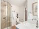 Updated bathroom with walk-in shower, natural stone tiling, and modern vanity at 2745 N Saint Paul St, Denver, CO 80205
